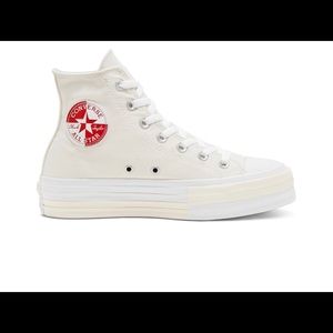 tan, white, & red platform chuck taylors.